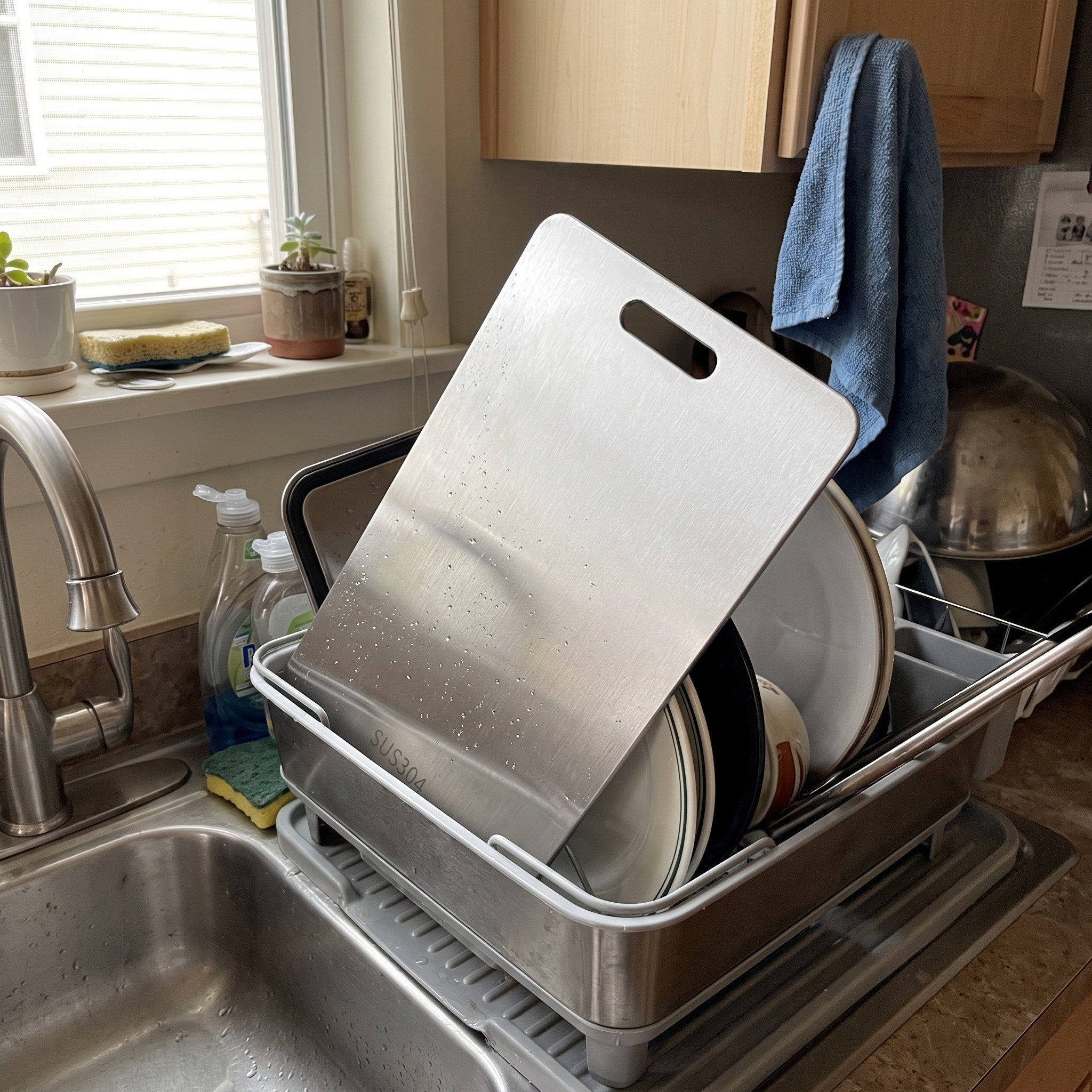 A clean steel board drying in the dish rack